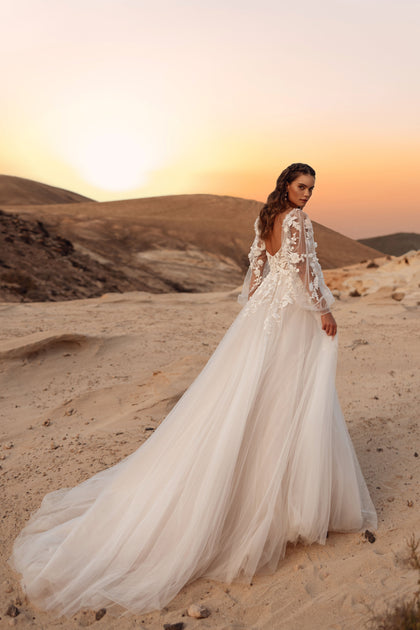 Alia’s rear view features a semi-sheer bodice and a gentle tulle train, accentuating the dress’s romantic allure.