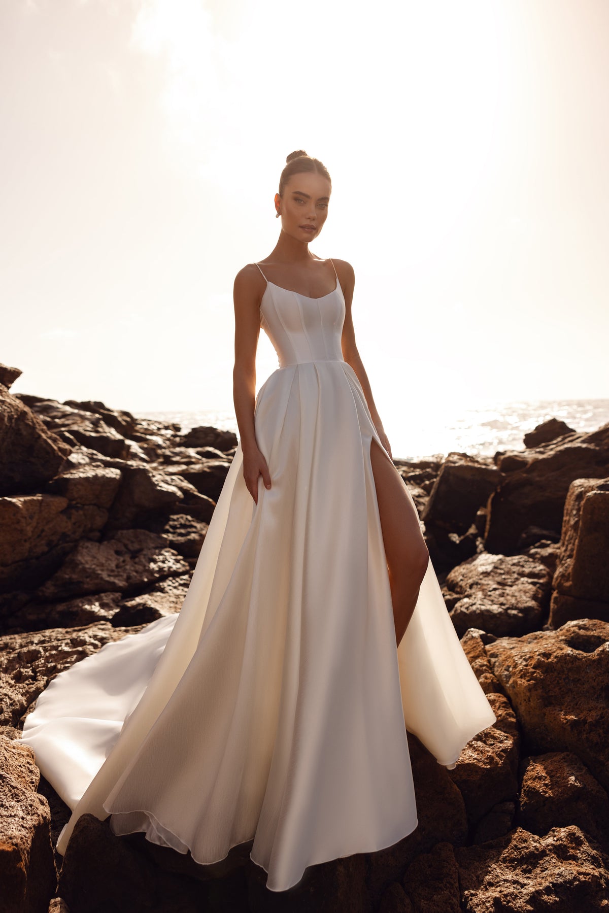Alya bridal dress made of matte satin with a corset top and thin straps, offering minimalist elegance from the front.