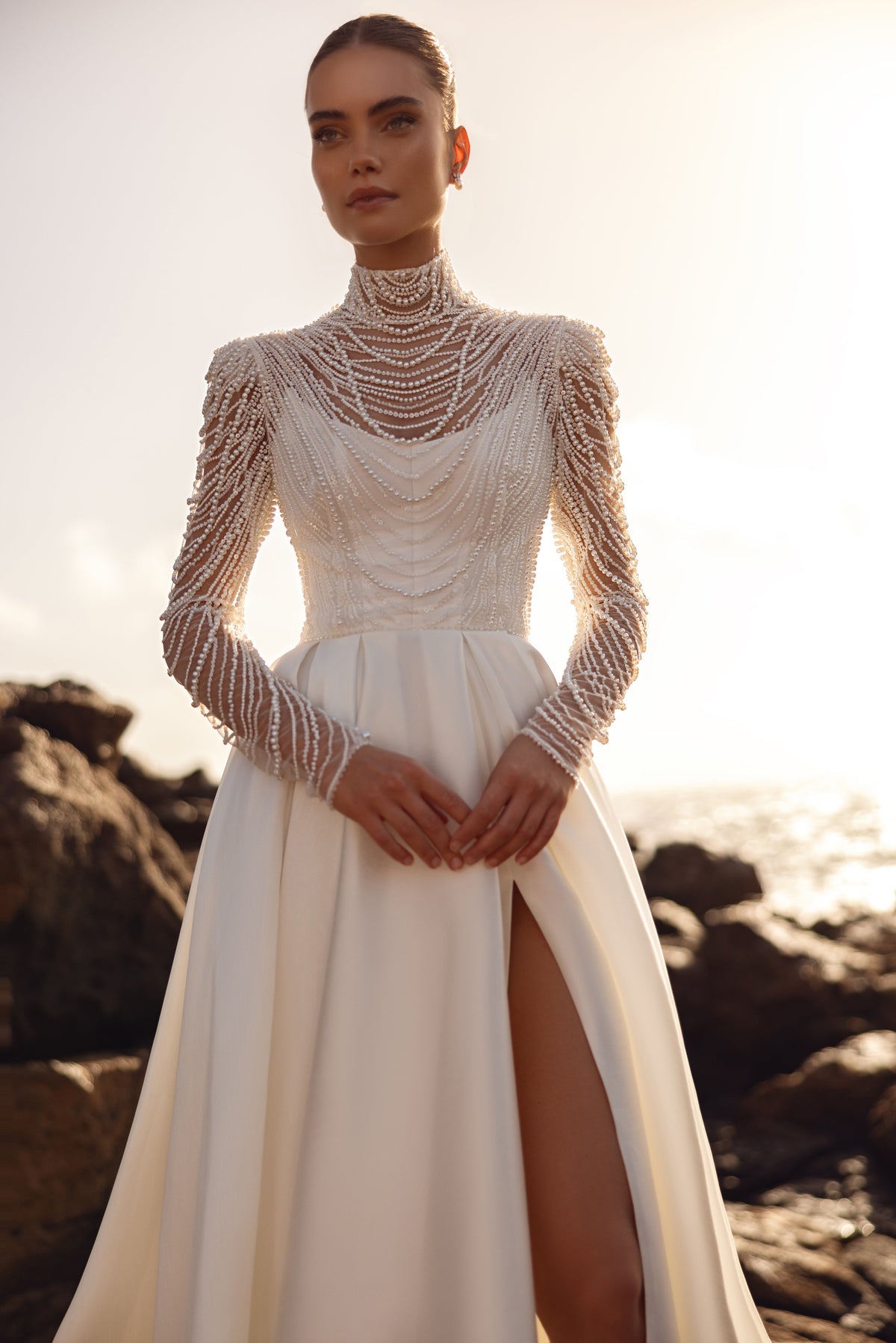Alya bridal blouse with pearl long sleeves and high-slit skirt highlights a modern, luxurious bridal look.