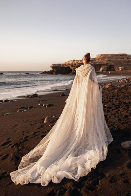 Amira’s rear view showcases a cathedral-length train, giving the gown a majestic and graceful presence.