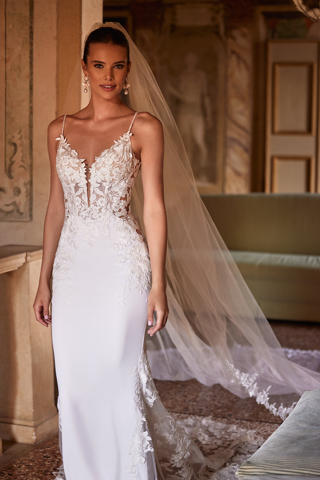 Long and classic Apolonia wedding veil trimmed with floral lace with comb attachment from Dama Couture wedding dress atelier (front photo)