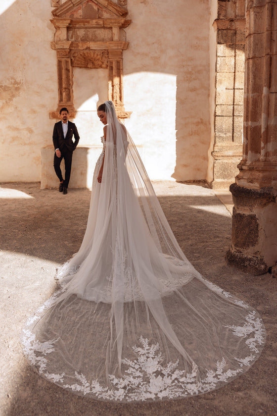 The Ariella cathedral wedding veil with lace trim adds a dramatic and timeless bridal look perfect for elegant ceremonies.