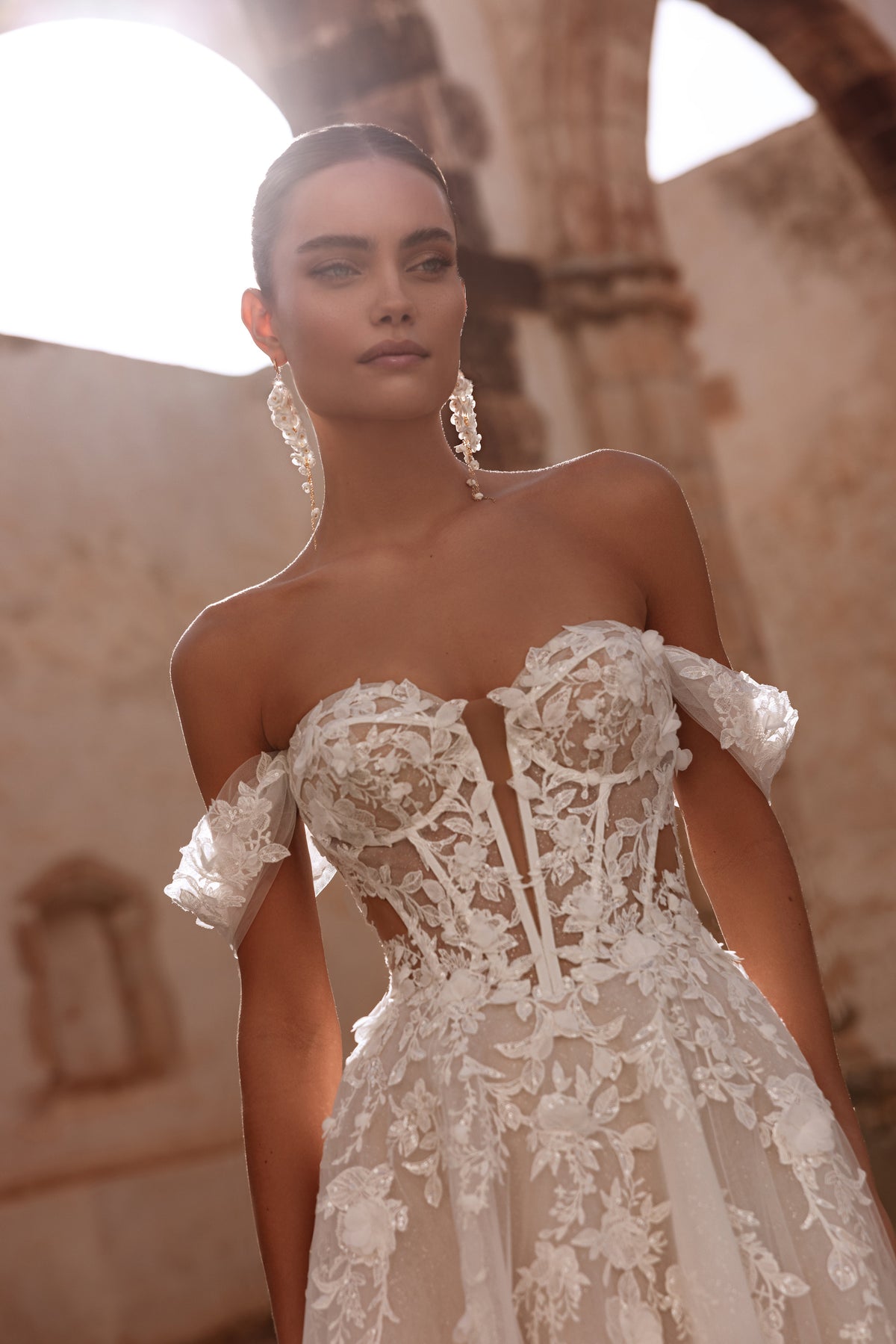Close-up of the Ariella corset shows finely applied floral lace motifs, emphasizing the dress’s romantic elegance.