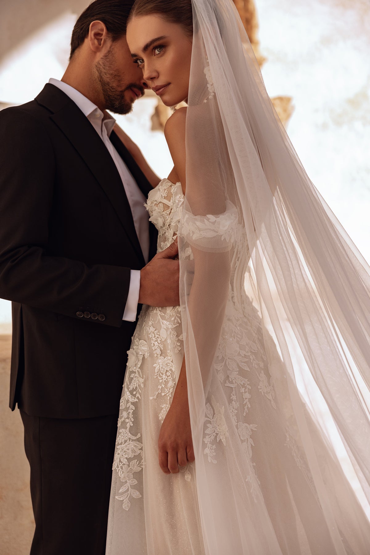 The Ariella long lace wedding veil with soft tulle creates a dreamy and romantic bridal look.