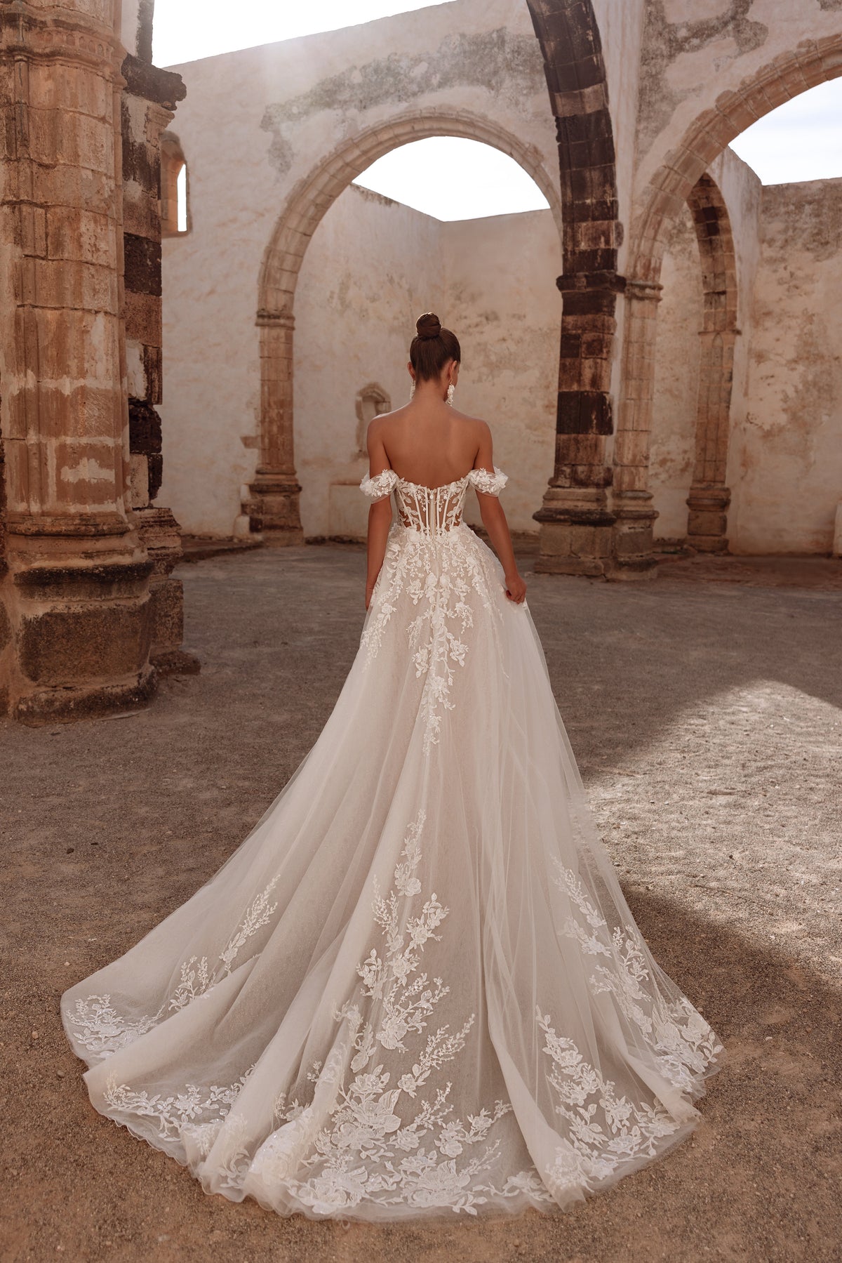 Ariella’s rear view includes a flowing train and a semi-transparent corset, giving the dress a majestic, regal feel.