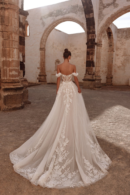 Ariella’s rear view includes a flowing train and a semi-transparent corset, giving the dress a majestic, regal feel.