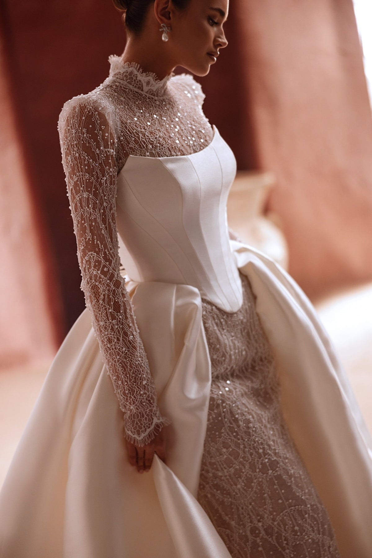 The Henriette overskirt combines detailed lace embroidery with satin overskirt for a glamorous bridal silhouette.