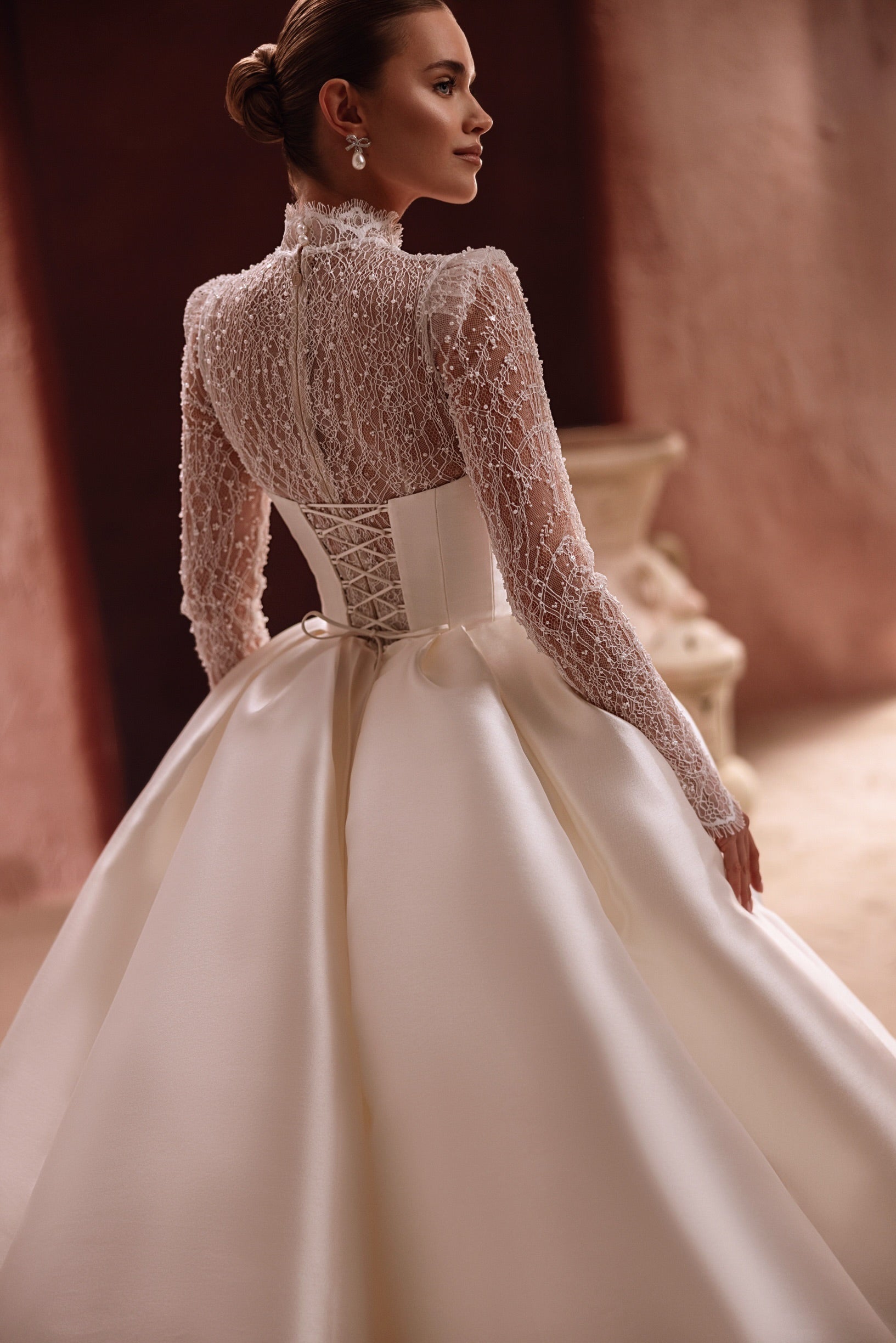 The Henriette satin overskirt with a dramatic cathedral train creates a glamorous and regal bridal look.