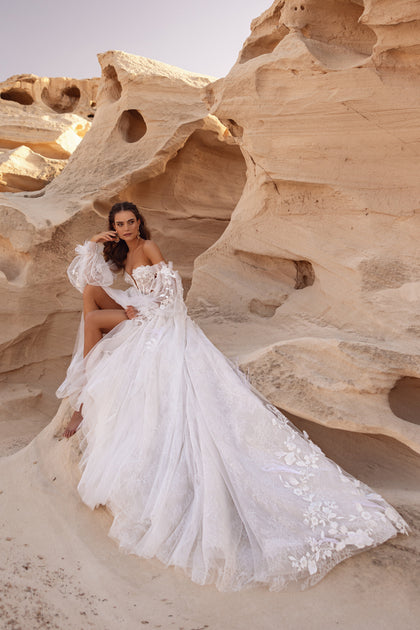 Close-up of the Huda wedding dress corset reveals delicate lace, corset lacing, and intricate 3D floral detailing.