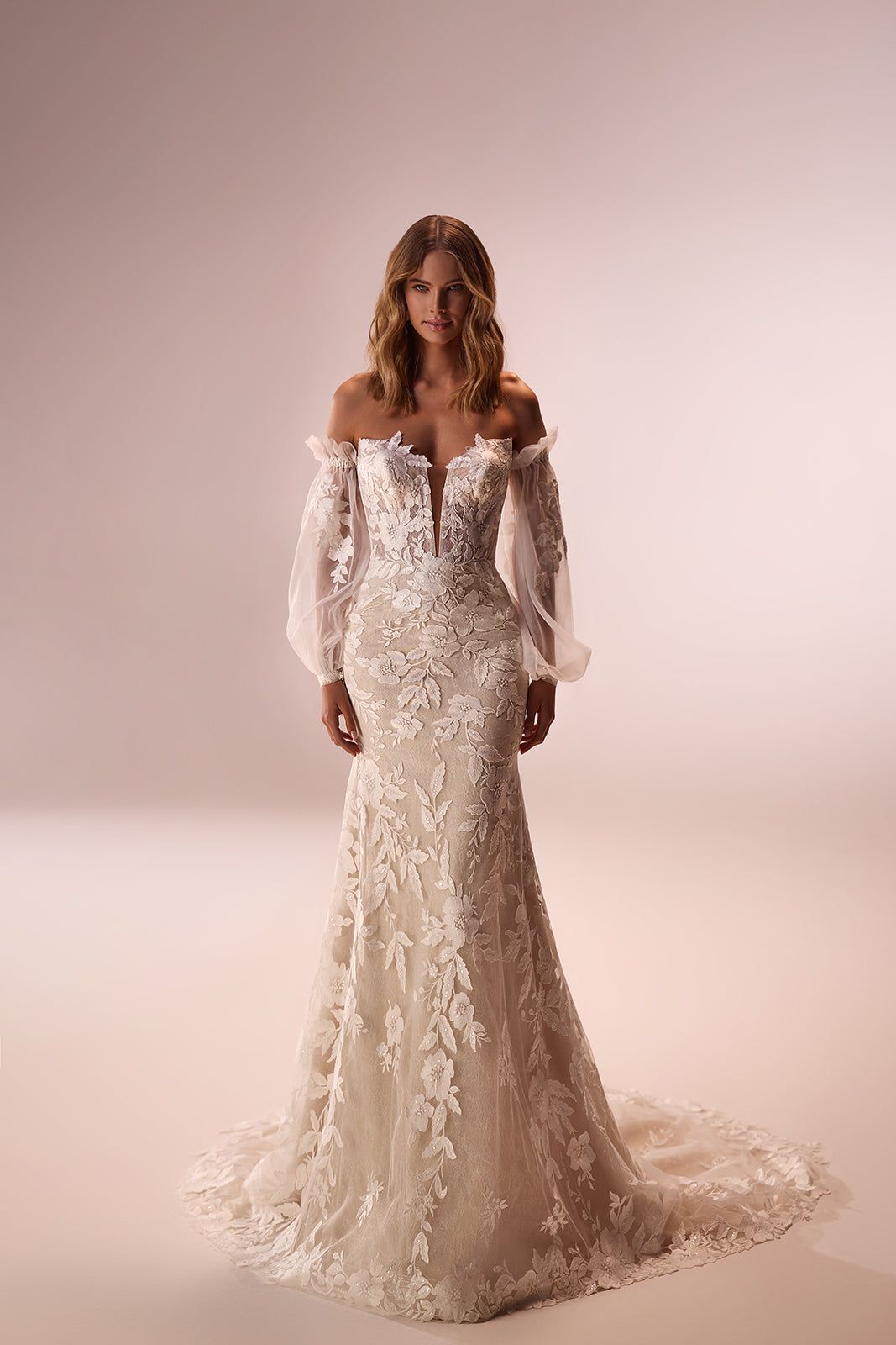 In the studio, Lucrezia wedding dress with floral lace following its fitted silhouette
