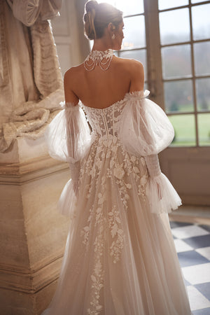 Estella wedding dress – a dimensional floral corset and voluminous off-the-shoulder sleeves.