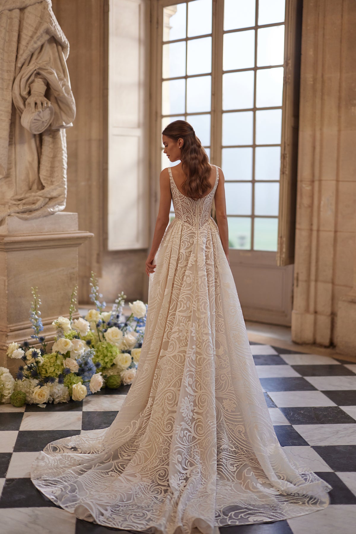 Frigga wedding dress – slender straps, a squared neckline and graphic lace ball skirt.