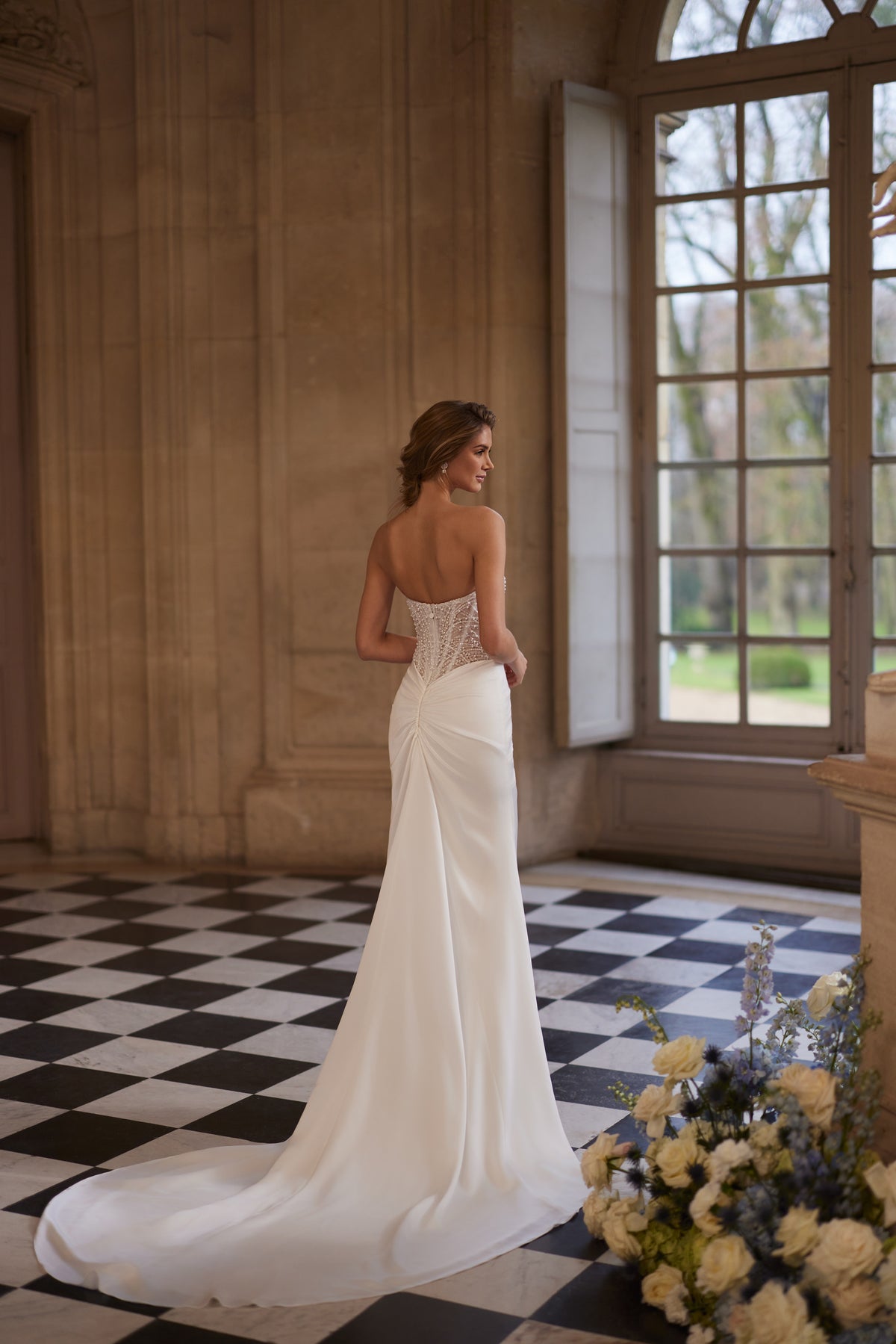 Greta wedding dress from the Something Blue 2027 collection – a richly beaded strapless corset and draped satin skirt.