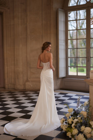 Greta wedding dress from the Something Blue 2027 collection – a richly beaded strapless corset and draped satin skirt.