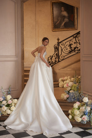 Lucienne wedding dress from the Something Blue 2027 collection – a crystal-embellished illusion neckline and draped satin skirt with a high slit.