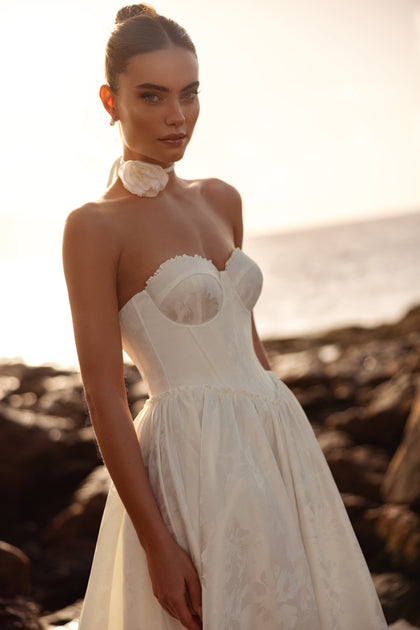 Close-up of the Cholly wedding dress featuring a structured corset and floral neck detail, perfect for a romantic bride.
