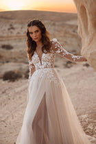 The Armori wedding dress with a long tulle train and lace bodice shines beautifully against the desert sunset backdrop.
