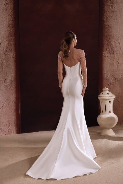 The Aylin satin wedding dress with a structured bodice and full skirt embodies regal elegance and luxury.