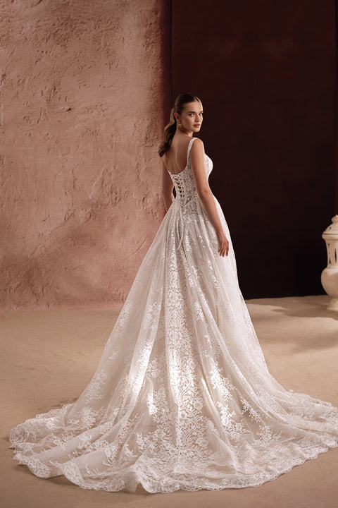 The Becco wedding gown features a lace bodice and full skirt, creating a romantic princess-style bridal look.