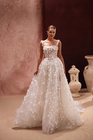 The Cintra wedding dress features a floral lace bodice with 3D appliqués, offering a luxurious and romantic bridal look.