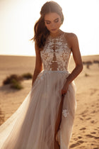 The Ellie bridal dress with a halter neckline and airy tulle layers captures a dreamy outdoor wedding style.