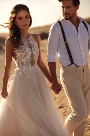 The back of the Ellie wedding gown features a delicate tulle tie and open-back design for a feminine, airy touch.