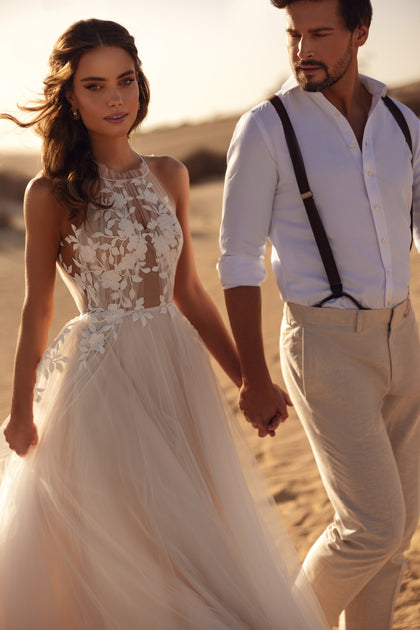 The back of the Ellie wedding gown features a delicate tulle tie and open-back design for a feminine, airy touch.