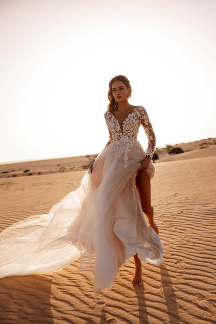 The Farida bridal gown combines an illusion lace bodice with a flowing tulle skirt, creating a dreamy wedding day silhouette.