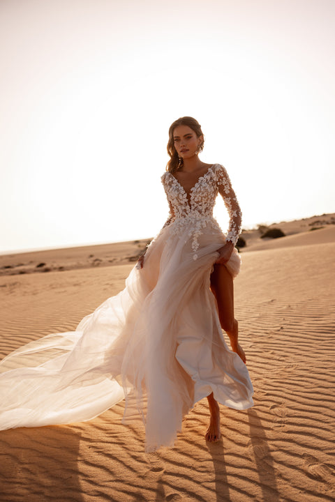 The Farida bridal gown combines an illusion lace bodice with a flowing tulle skirt, creating a dreamy wedding day silhouette.