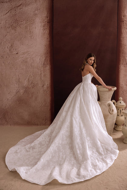 The Hebe wedding gown combines timeless ball gown style with modern details like pockets and floral jacquard.
