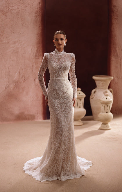 The Henriette wedding dress features a high-neck lace bodice with long sleeves and delicate beading for timeless bridal elegance.