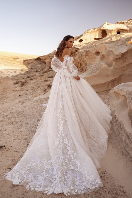The Huda wedding dress with an embroidered floral train and layered tulle skirt embodies fairytale bridal glamour.