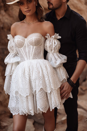 The back of the Jolena wedding dress showcases a lace-up corset and off-the-shoulder sleeves, exuding romantic boho charm.