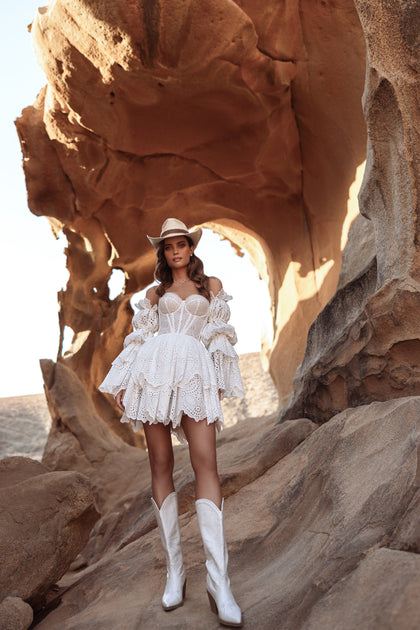 The Jolena wedding dress features puff sleeves and a tiered cotton lace skirt, perfect for a rustic country boho bride.