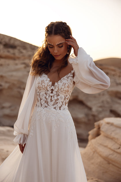 The Judith wedding dress with a long embroidered train captures timeless romance and modern elegance.