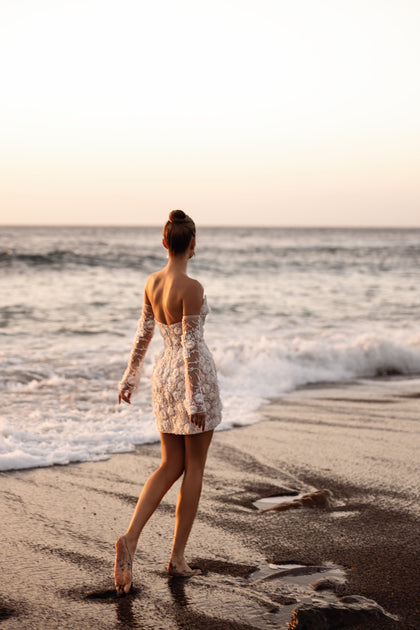 The Kayla wedding dress features intricate lace with 3D floral texture and a fitted bodice that defines the waist beautifully.