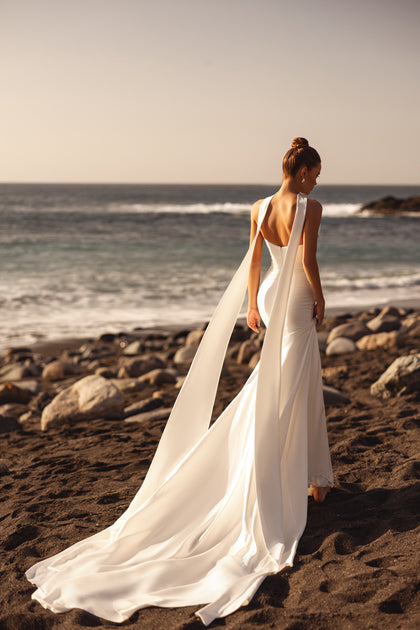 The Luna wedding dress with a draped neckline accentuates feminine curves with effortless sophistication.