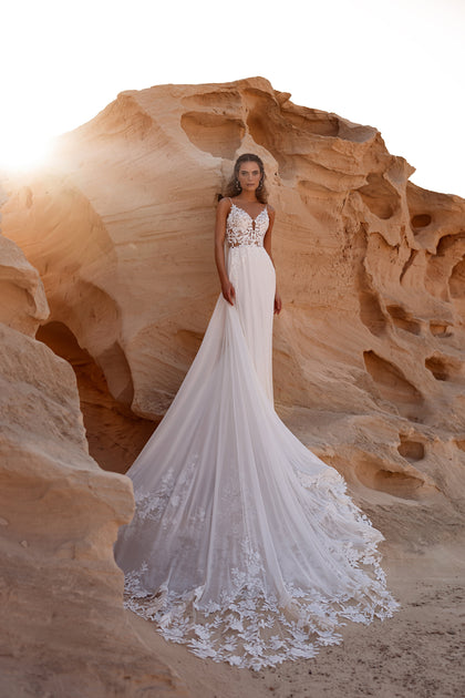 The Malika wedding dress features a leaf lace bodice with delicate straps — a dreamy boho bridal gown for modern brides.