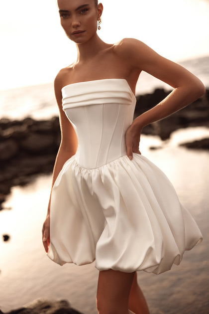 Martini short wedding dress with a structured bustier corset and bubble skirt is a modern, chic choice for the stylish bride.