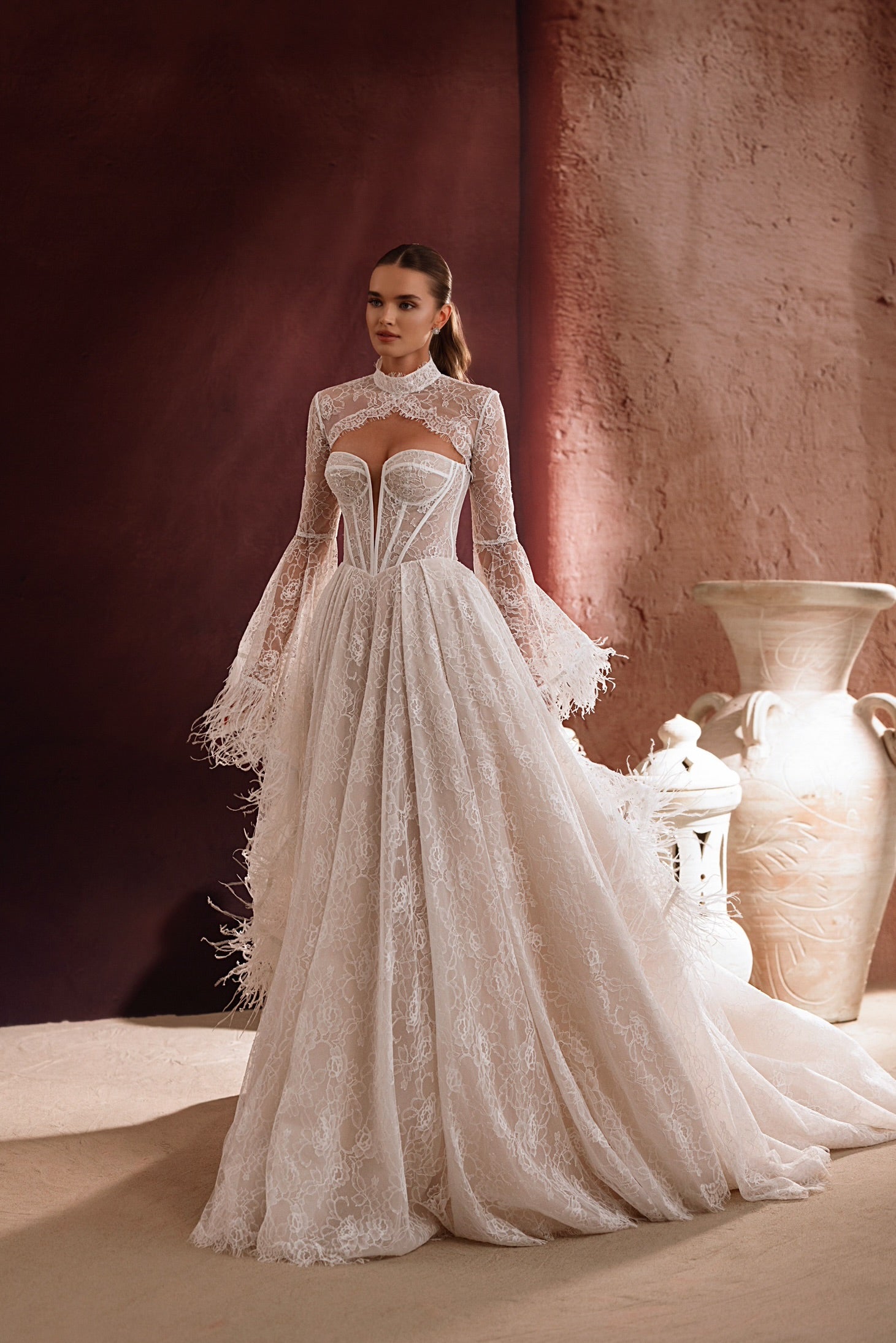 The Michelle bridal lace bolero with long sleeves and high neckline adds elegance and sophistication to any wedding dress.