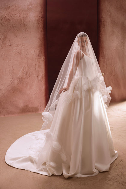 The back of the Nicolette wedding dress features a deep V-cut, adding a touch of femininity to its minimalist bridal design.