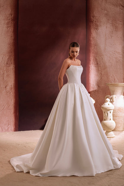 The Noor princess ball gown wedding dress with a pearl-embellished bodice defines luxury and timeless bridal beauty.