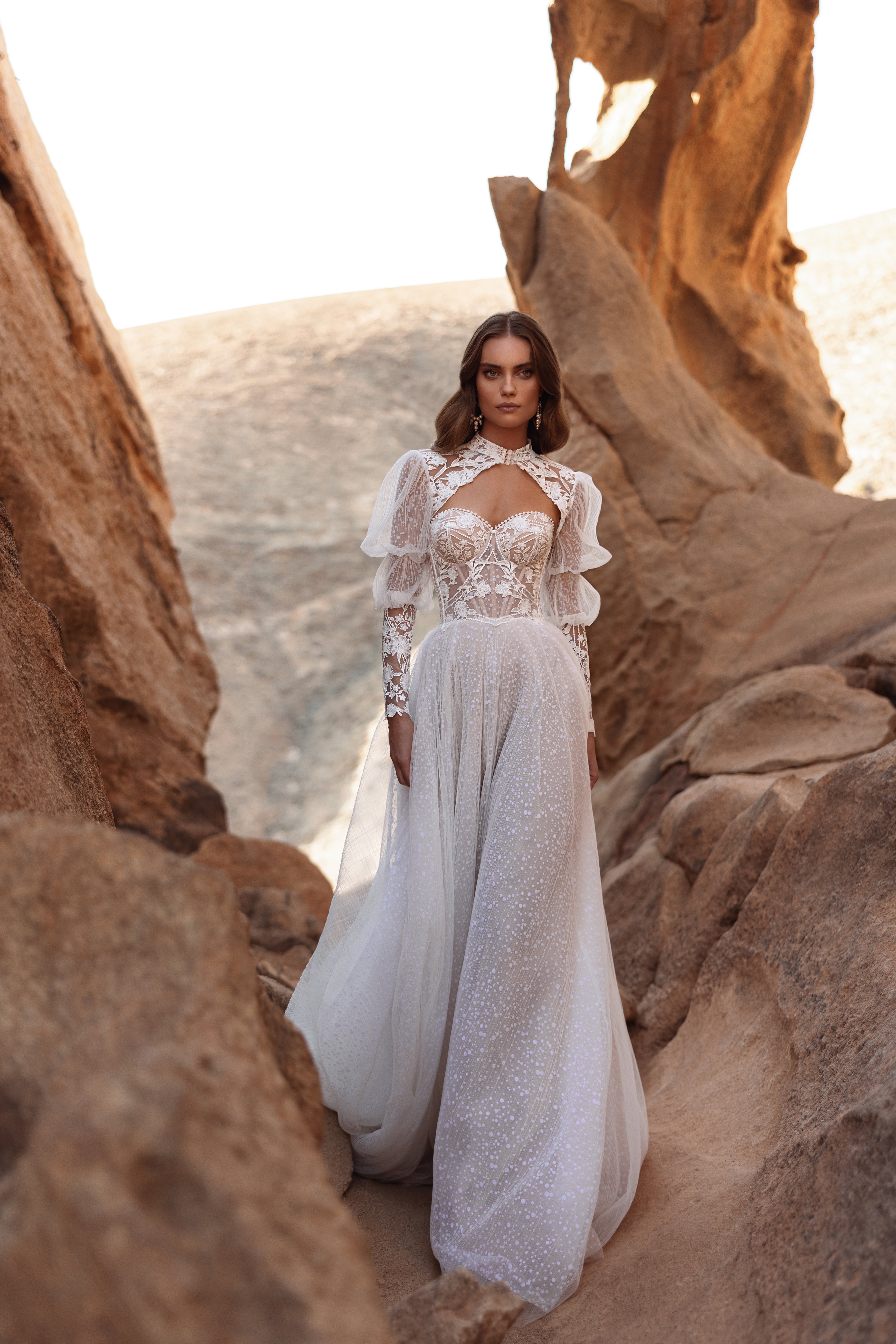 The Oasis wedding dress with a lace bodice and airy tulle skirt shimmers softly, highlighting the bride’s natural beauty.