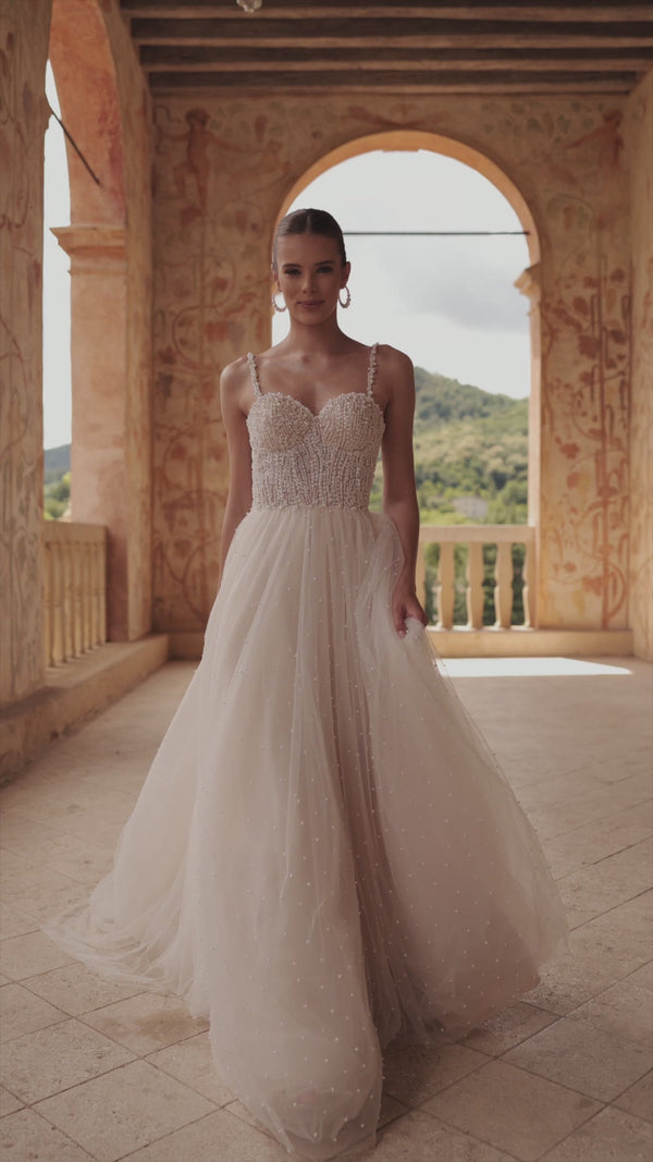 Glamour wedding dress with pearls Perla from DAMA Couture (campaign video)
