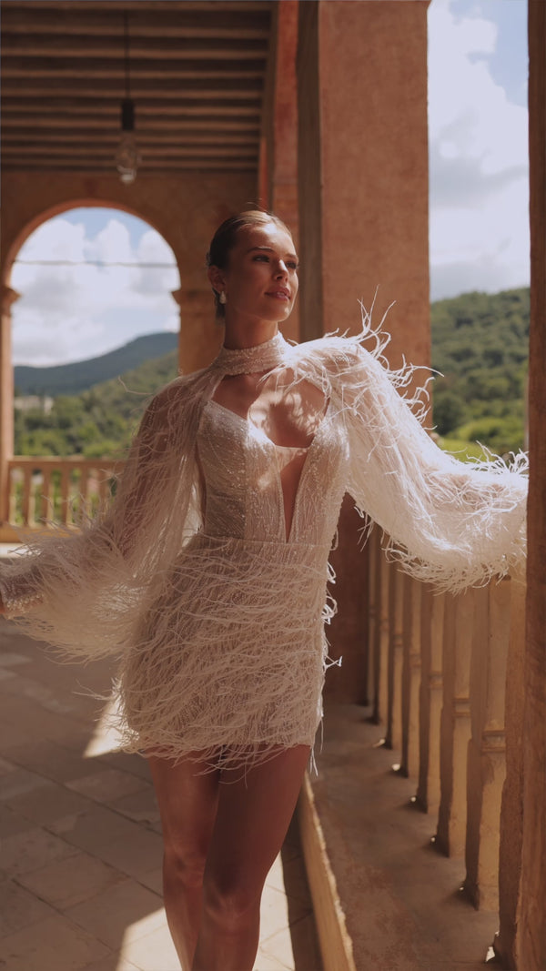 Short trendy wedding dress with feathers and bolero Viva from DAMA Couture (campaign video)