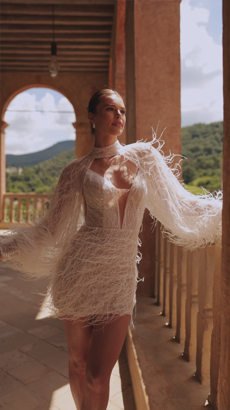 Short trendy wedding dress with feathers and bolero Viva from DAMA Couture (campaign video)