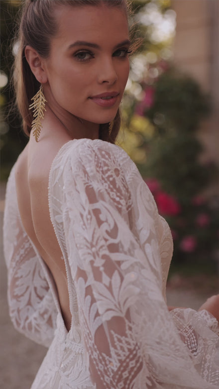 Bohemian lace a-line wedding dress with sleeves Noya from DAMA Couture (campaign video)