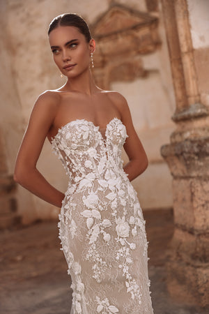 The Sarifa lace wedding dress with dramatic train and floral details exudes luxury and modern romance.