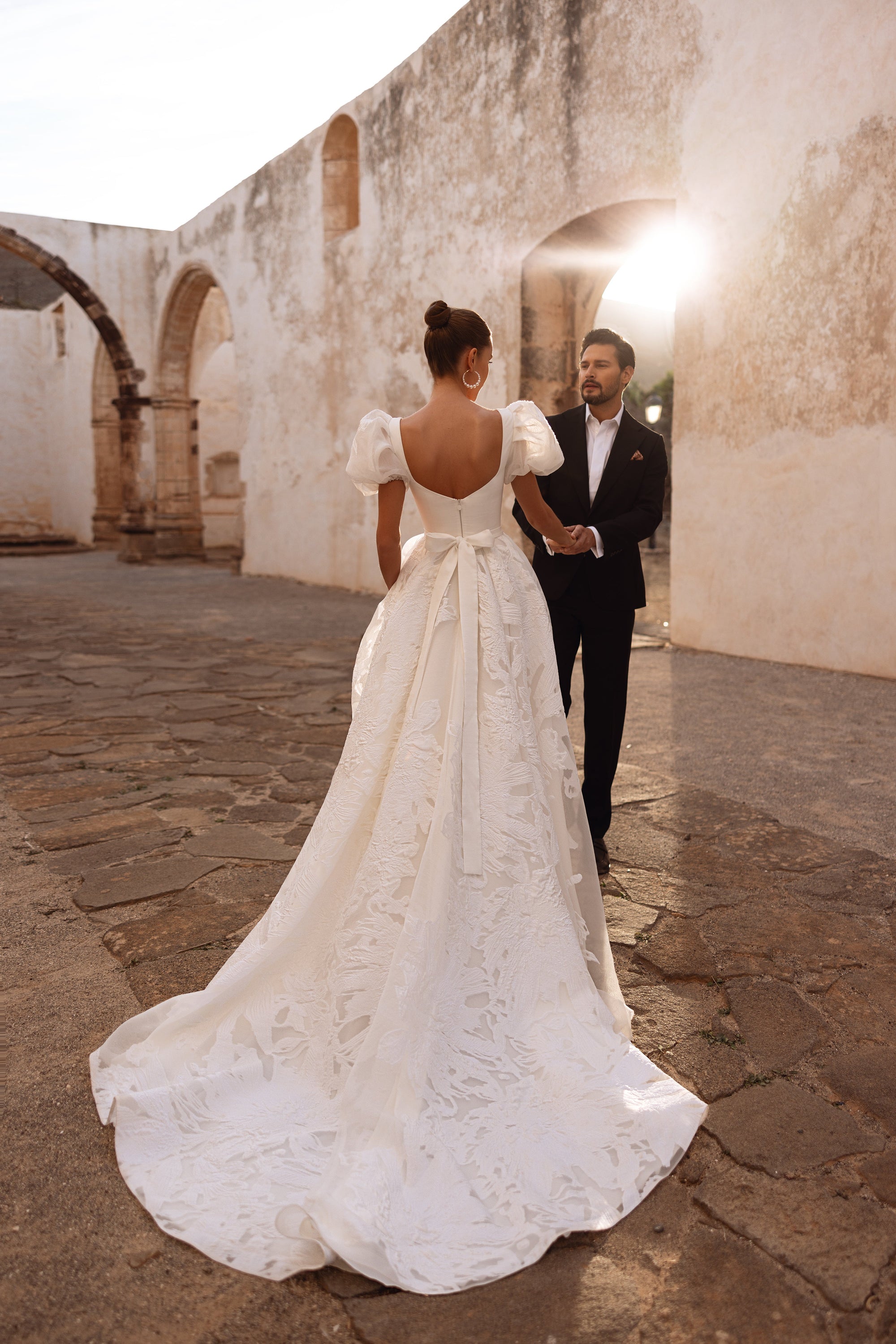 The Vanilla wedding dress with a structured bodice and embroidered tulle skirt captures refined bridal luxury.